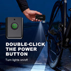 Cyclist using the built-in LED emergency flashlight of the TOWILD A05 electric pump to illuminate the bike cassette during a nighttime roadside repair.