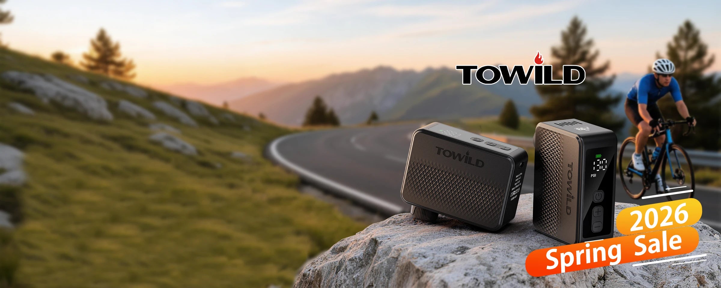 TOWILD 2026 Spring Sale promotional banner featuring the A13 mini electric bike pump on a rock, with a cyclist riding on a scenic mountain road in the background.