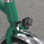 The versatile TOWILD AS60 mount shown holding a GoPro action camera on the front fork of a folding bike, perfect for capturing POV footage on a city commute.