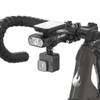 TOWILD BL1500 stacked below a bike computer and above an action camera on a road-bike cockpit.