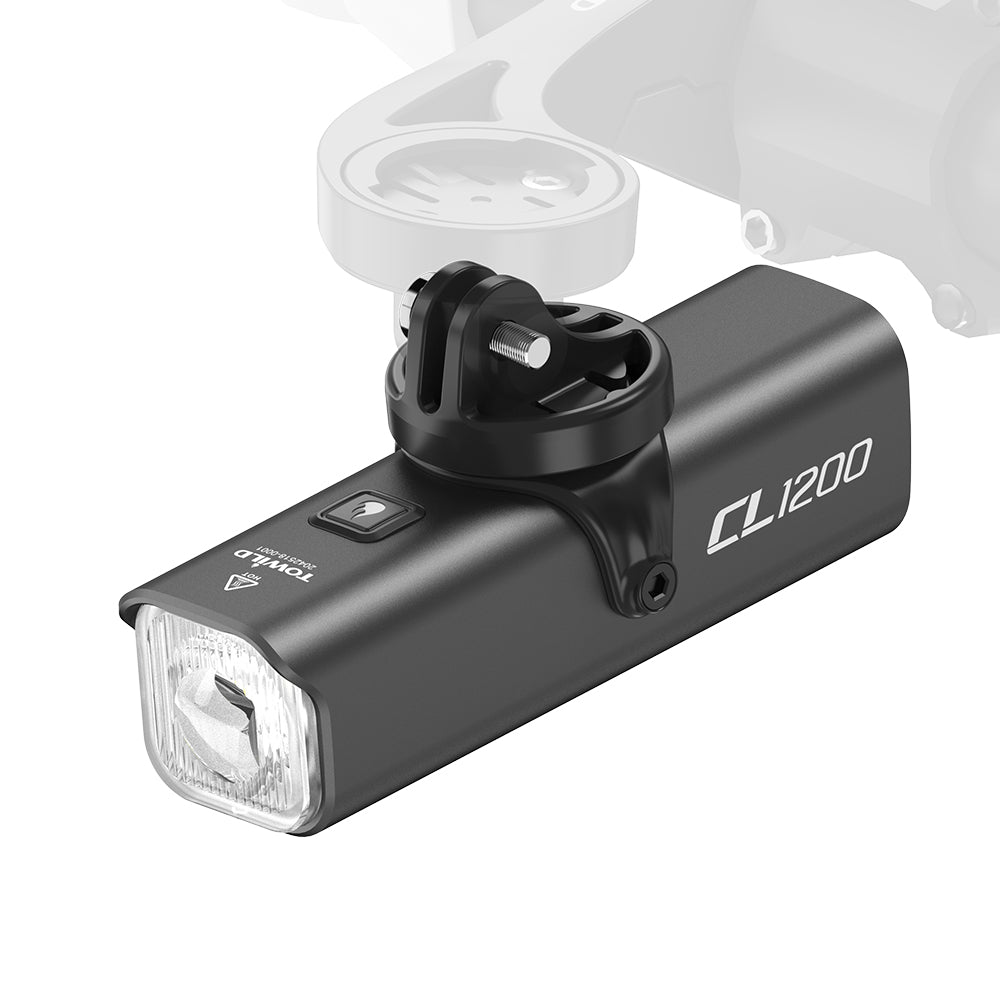A close-up of the TOWILD black CL1200 smart bike light, showing how its included GoPro mount adapter connects to a Garmin-style bike computer mount for an under-slung setup.
