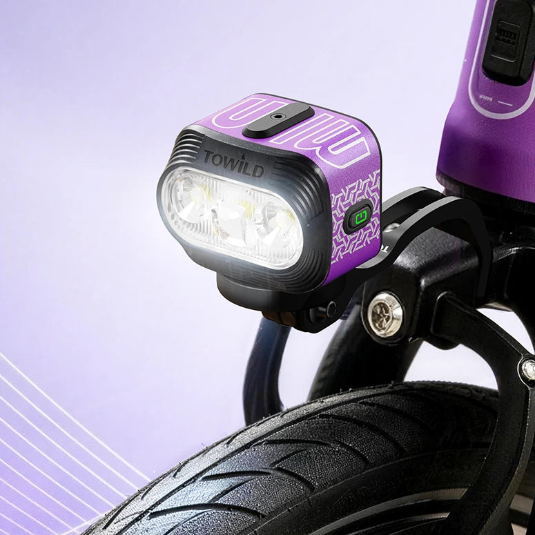 TOWILD BLMINI purple bike light mounted above the front wheel of a folding bicycle