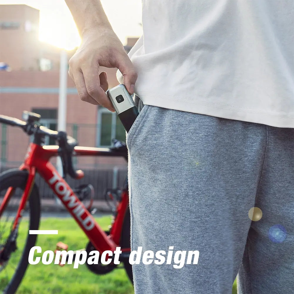 A cyclist placing the compact, pocket-sized Towild BR1000 bike light into their pocket, demonstrating its portability for travel and everyday carry.
