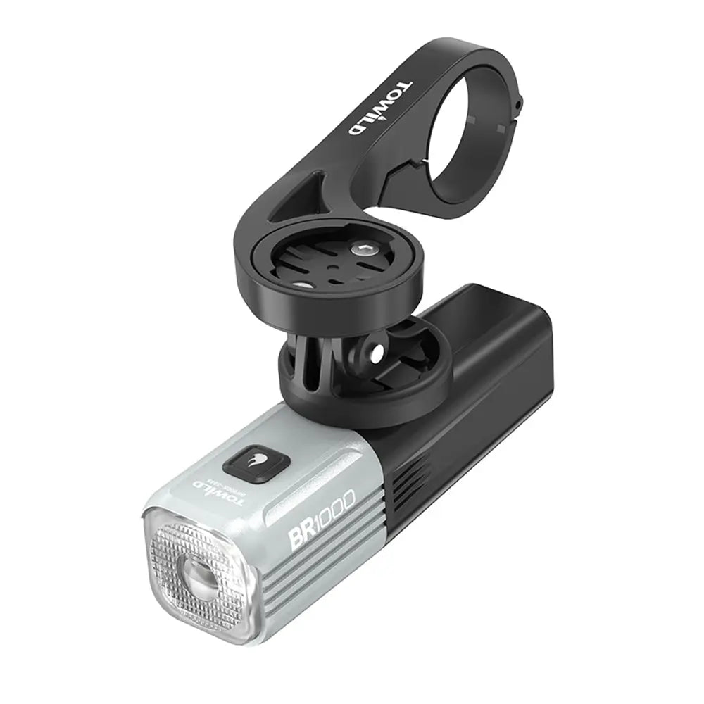The grey Towild BR1000 bike light installed in an underslung position on the AS90 out-front mount, showcasing the clean cockpit setup possible with its GoPro-compatible base.