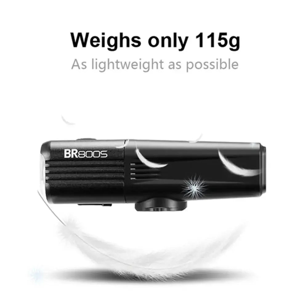 An image illustrating the lightweight 115g design of the TOWILD BR800s bike light with feathers.