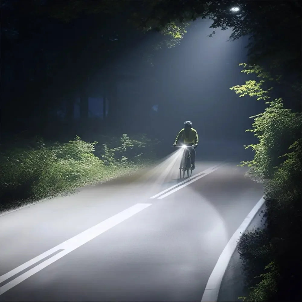 A cyclist riding on a dark road at night, powerfully illuminated by the long-range beam of the TOWILD BR800s bike light.