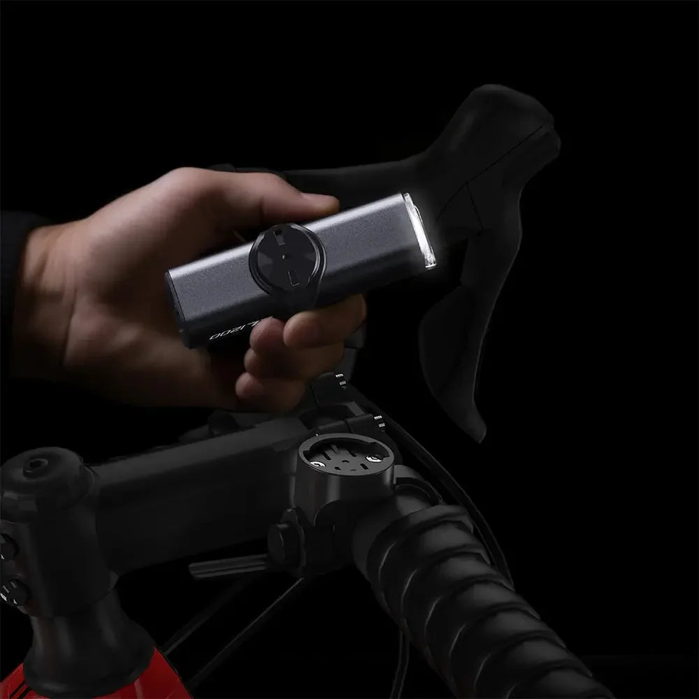 A cyclist demonstrating the versatile mounting options of the TOWILD CL1000, showing both top and underslung positions.