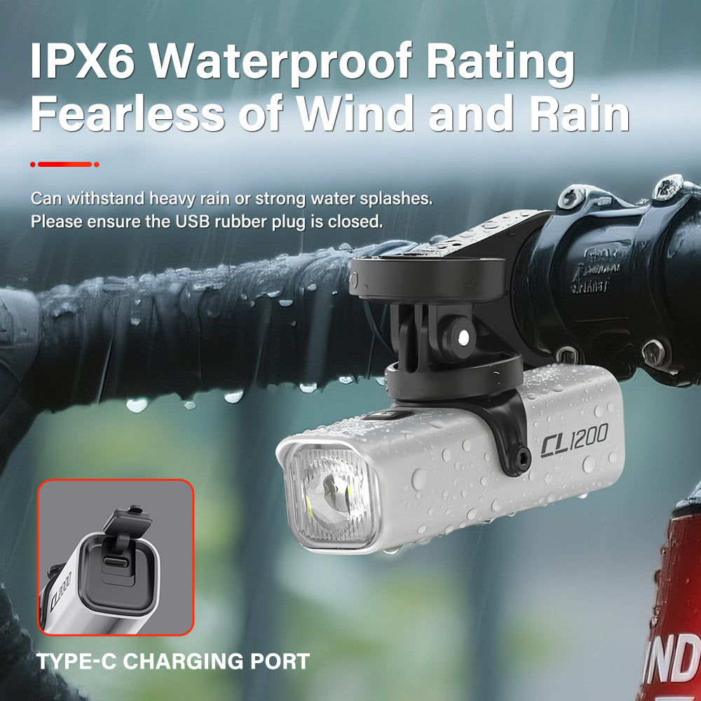 The white TOWILD CL1200 bike light demonstrating its IPX6 waterproof rating, shown under-mounted and covered in water droplets with its Type-C charging port securely sealed.