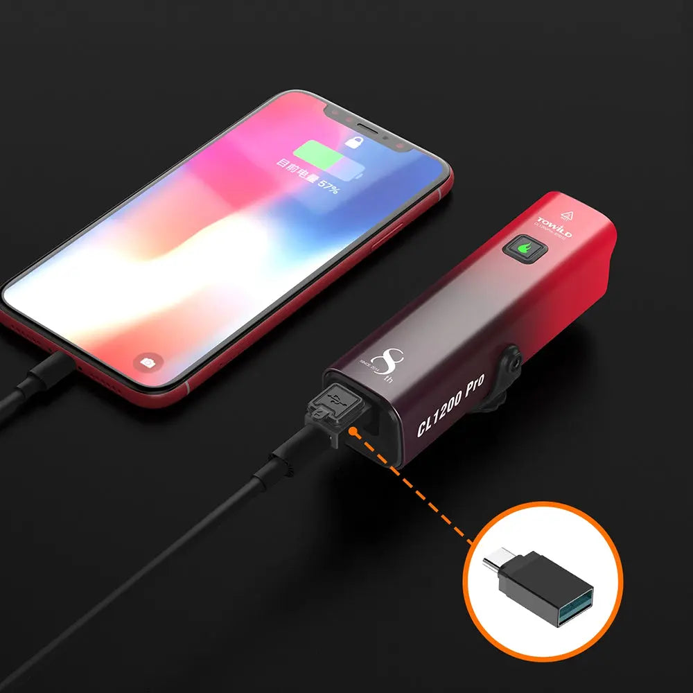 The TOWILD CL1200 Pro bike light in its red gradient finish being used as a USB-C power bank to charge a smartphone.
