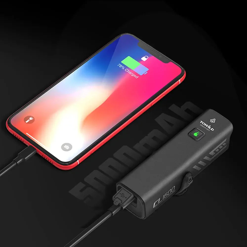 The TOWILD CL1600 bike light demonstrating its power bank feature, using its 5000mAh battery and a Type-C cable to charge a smartphone.