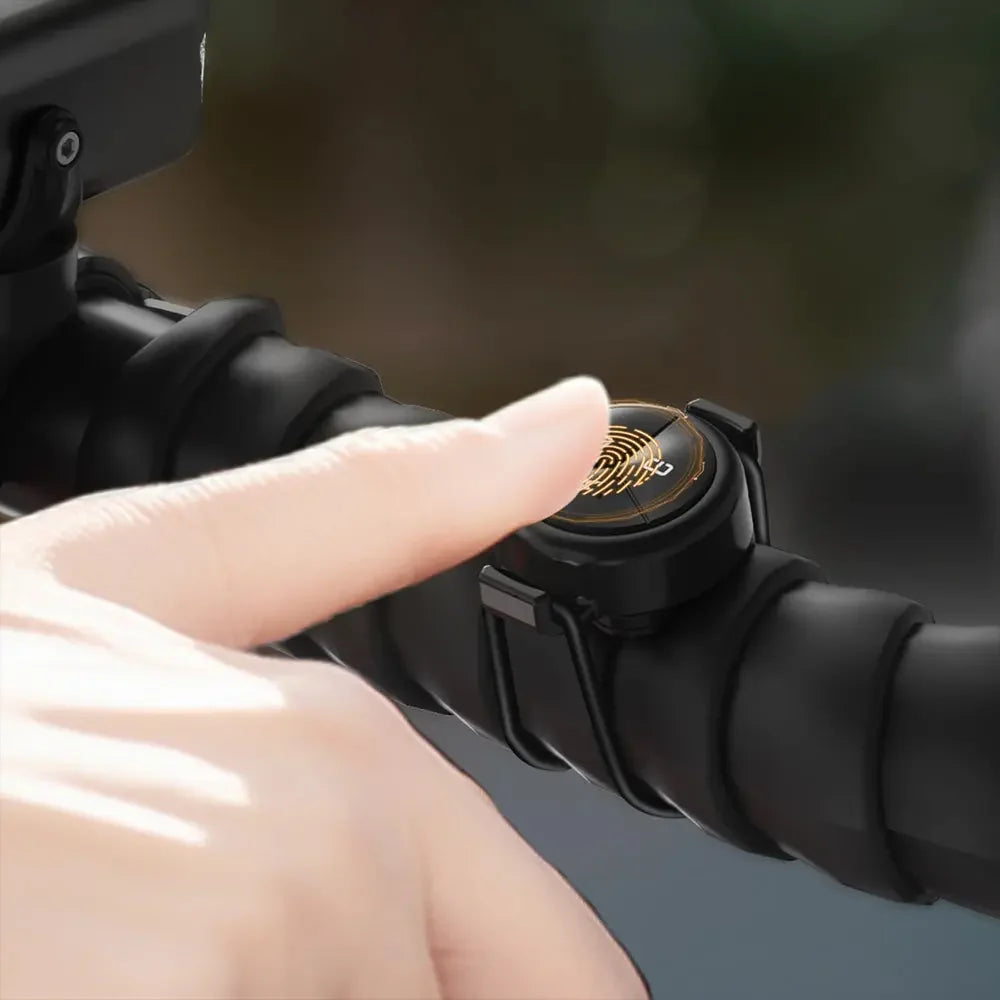 A close-up of a finger about to press the wireless remote for the TOWILD CL1600 bike light, which is mounted on the handlebar for easy access to change modes.