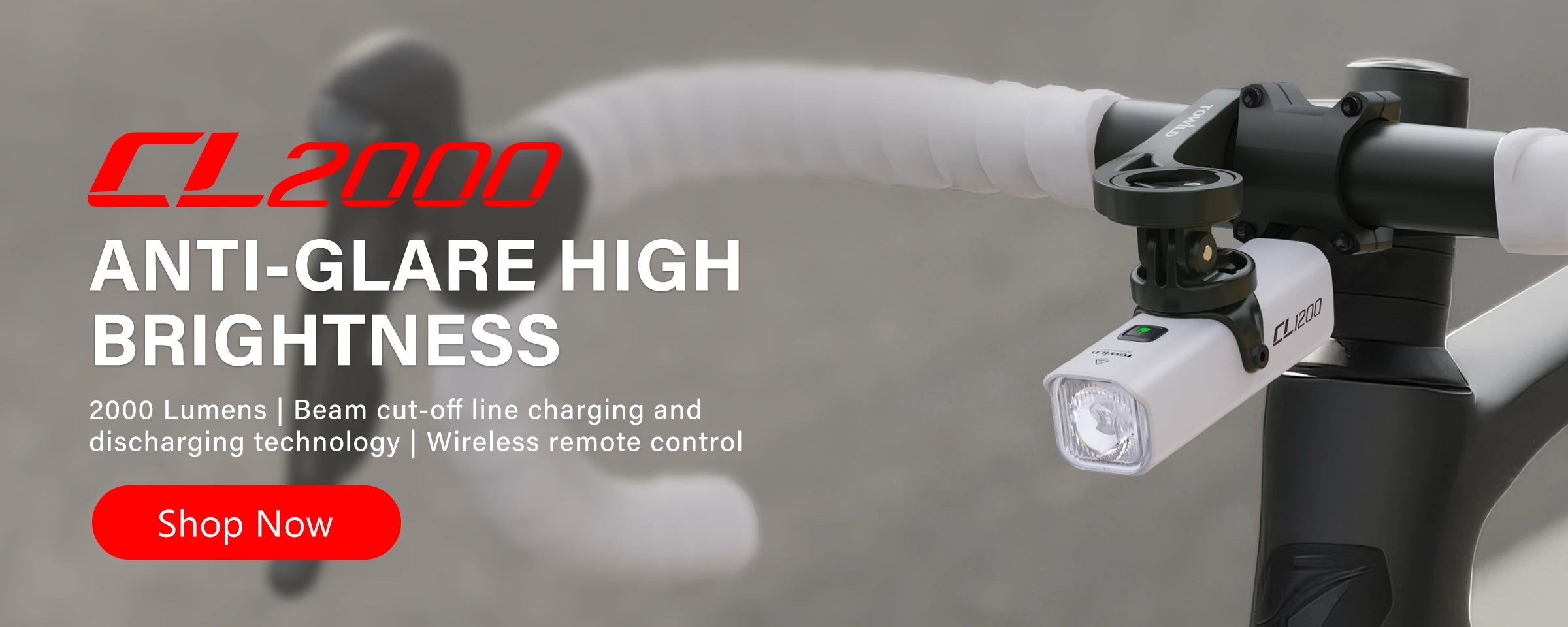 Towild CL2000 smart bike headlight mounted on road bike handlebars. Features wireless remote control, 2000 lumens output, and intelligent vibration sensing.
