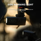 Promotional image of the TOWILD CL450 bike light at dusk, with its side warning light actively illuminated to alert pedestrians and vehicles for enhanced cycling safety.