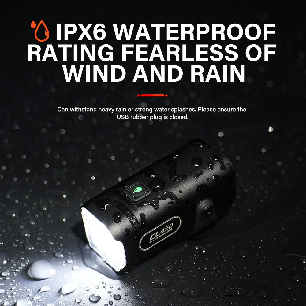 Promotional image of the TOWILD CL450 bike light demonstrating its IPX6 waterproof rating, showing the light turned on and covered in water droplets on a wet surface.