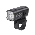 A three-quarters view of the black TOWILD CL450 smart bike light, showing its anti-glare lens and the included silicone handlebar mounting strap.