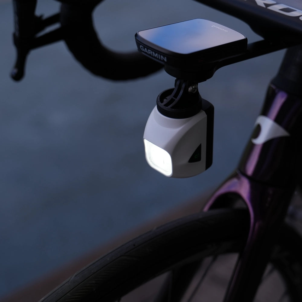 Towild DL1200S switched on, displaying its powerful 1200-lumen beam. The side warning window is also illuminated for enhanced safety.