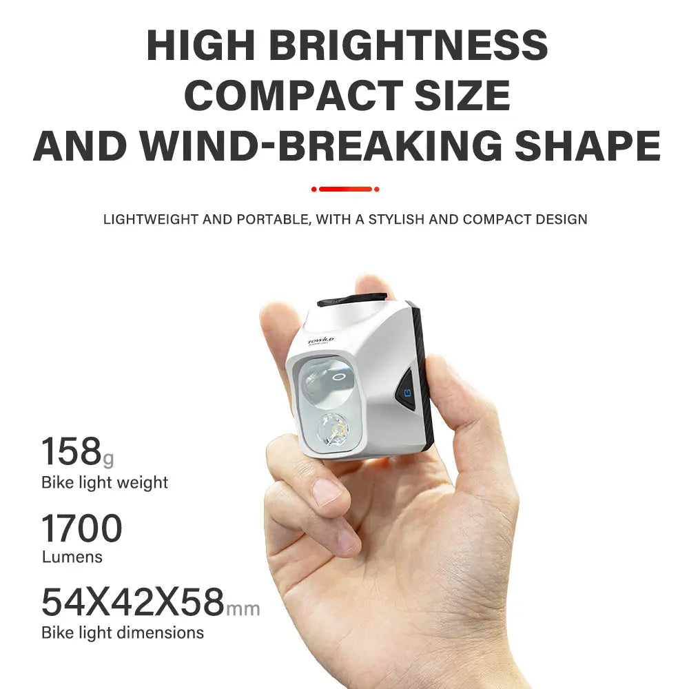 A hand holding the compact and lightweight Towild DLite1700 bike light, showcasing its powerful 1700-lumen output in a 158g, aerodynamic body.
