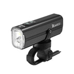 A front three-quarters view of the black TOWILD DLite1800 dual beam bike light, showing its two distinct lenses for flood and focus beams, attached to its standard handlebar mount.