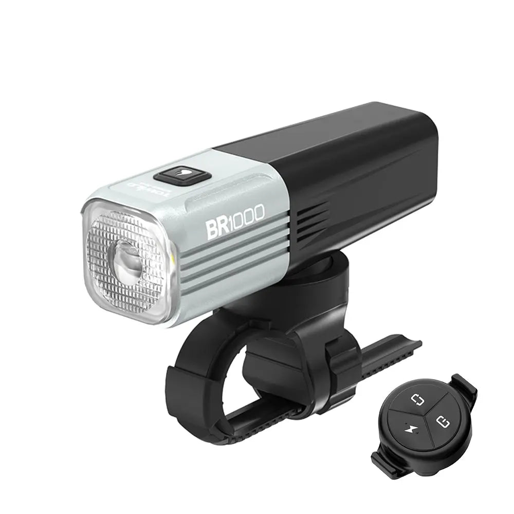 The grey Towild BR1000 lightweight bike light has a replaceable battery and comes with a handlebar mount and  Wireless Remote Control