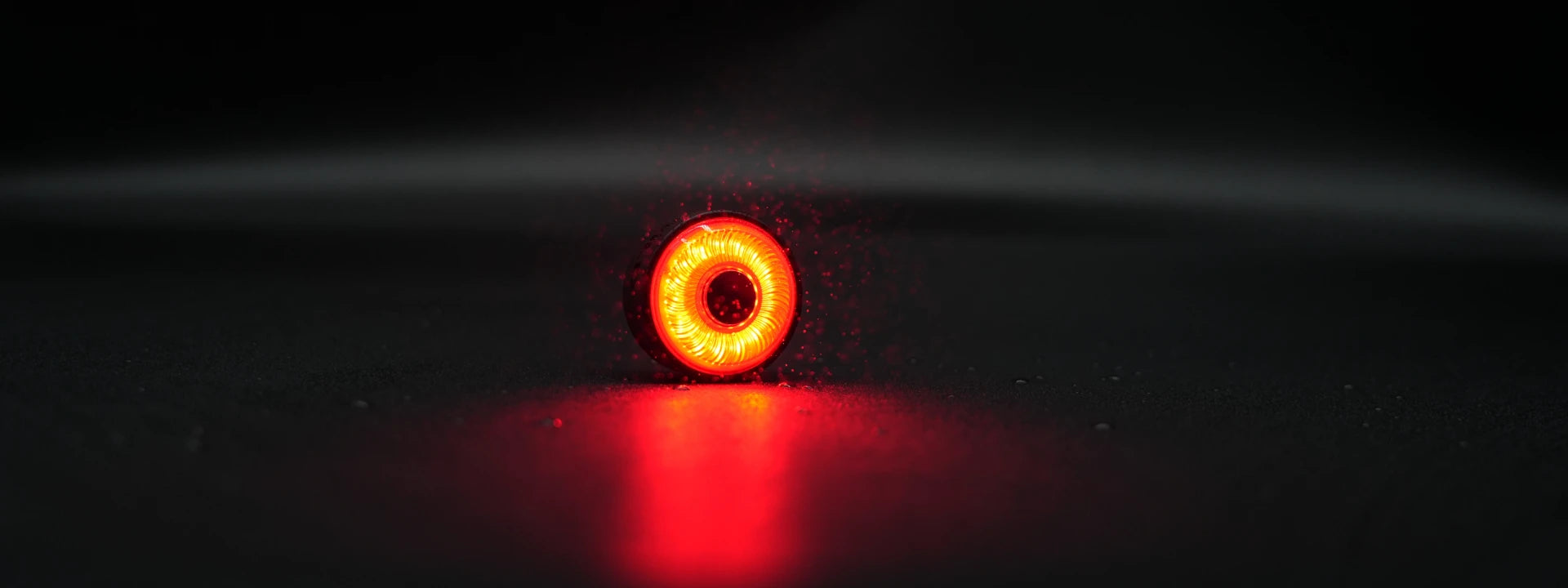 Video thumbnail for Towild TL03 smart tail light. Cinematic shot of the glowing red brake light in wet conditions, demonstrating IPX6 waterproof durability and high visibility for night riding safety.