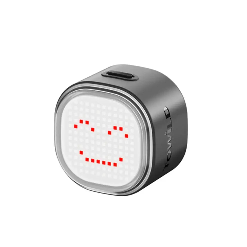 TOWILD TL08 DIY programmable bike tail light displaying a custom red smiley face pixel art animation.